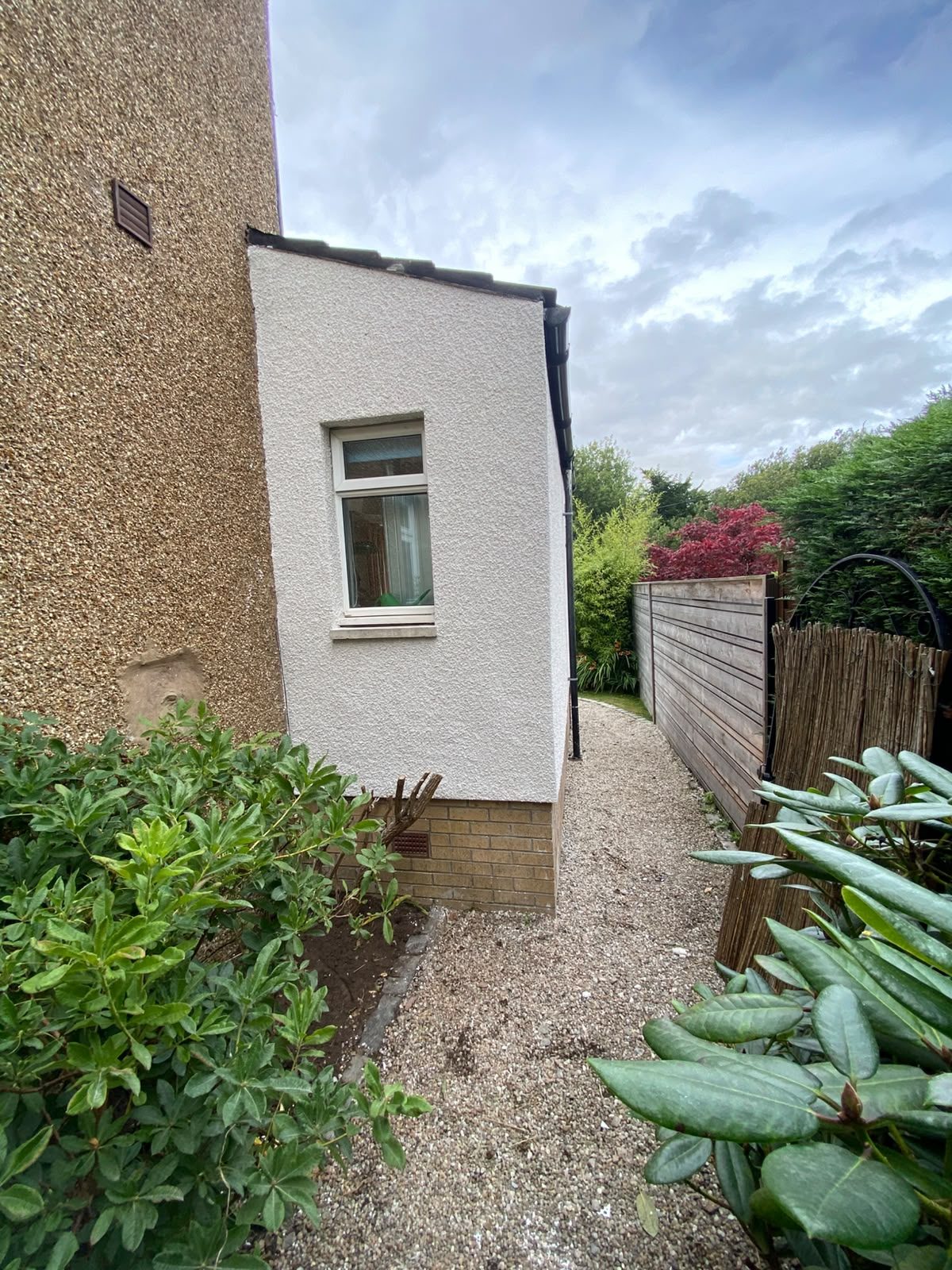 Rendered extension against the original roughcast house